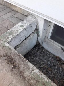 damaged stone window well